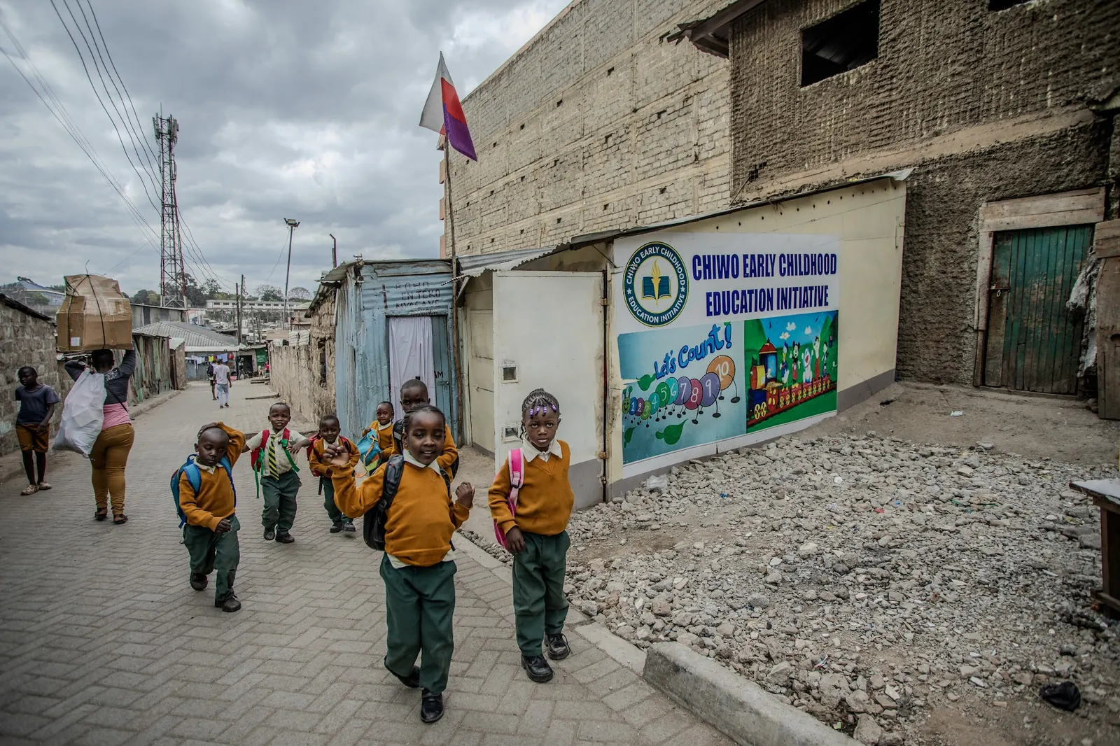 Children with school bags walking up the lane to CHIWO